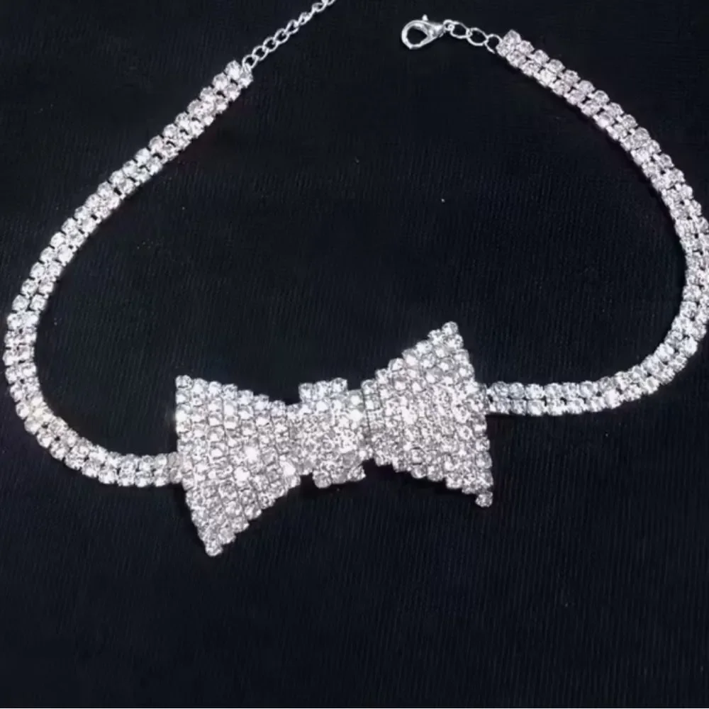 Dazzling crystal bow centerpiece on a sparkling choker. Elegant, eye-catching.